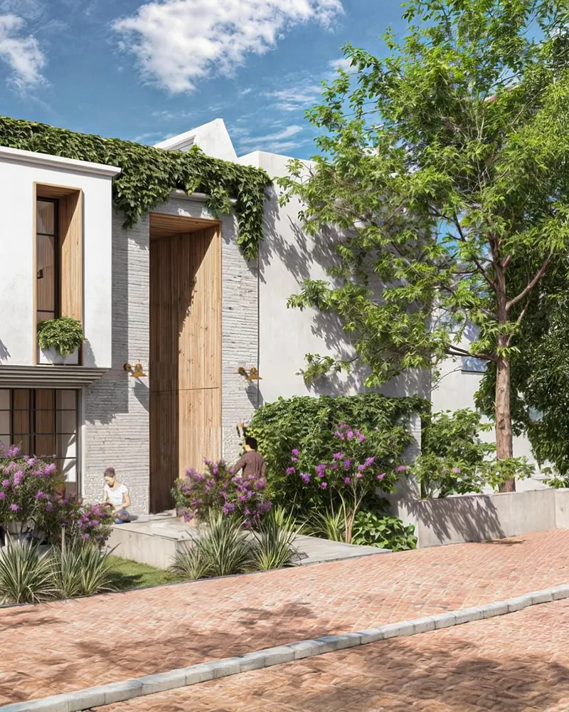 Fachada con ingreso de doble altura y jardines